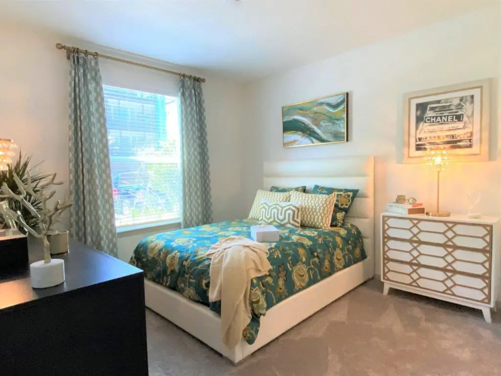 The Addison at Universal Boulevard One Bedroom Model Gallery- bedroom with two dressers and queen bed