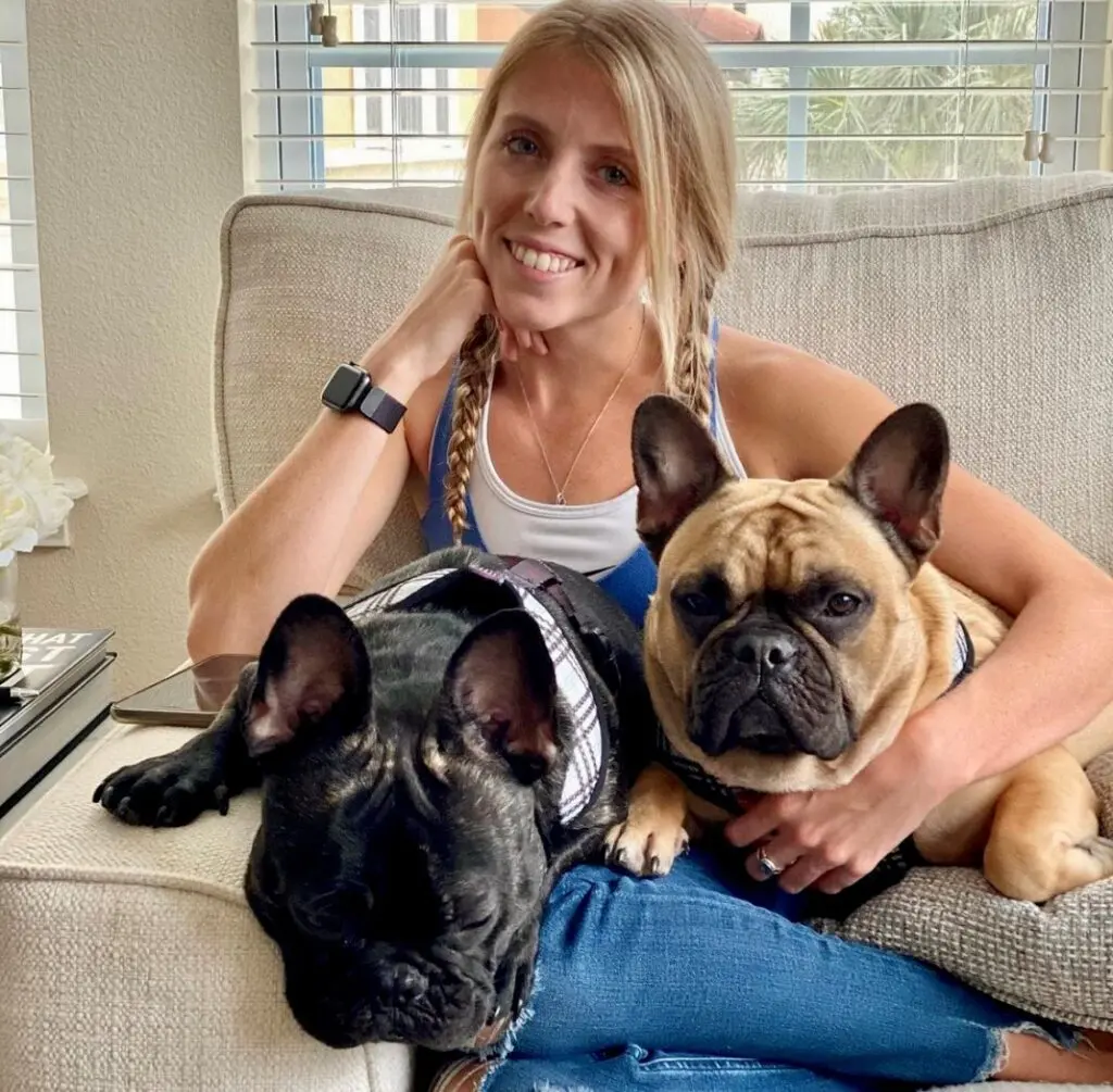 Young woman with two Frenchie dogs