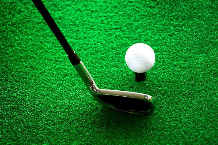 Golf club and ball lined up for swing