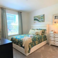 The Addison at Universal Boulevard One Bedroom Model Gallery- bedroom with two dressers and queen bed
