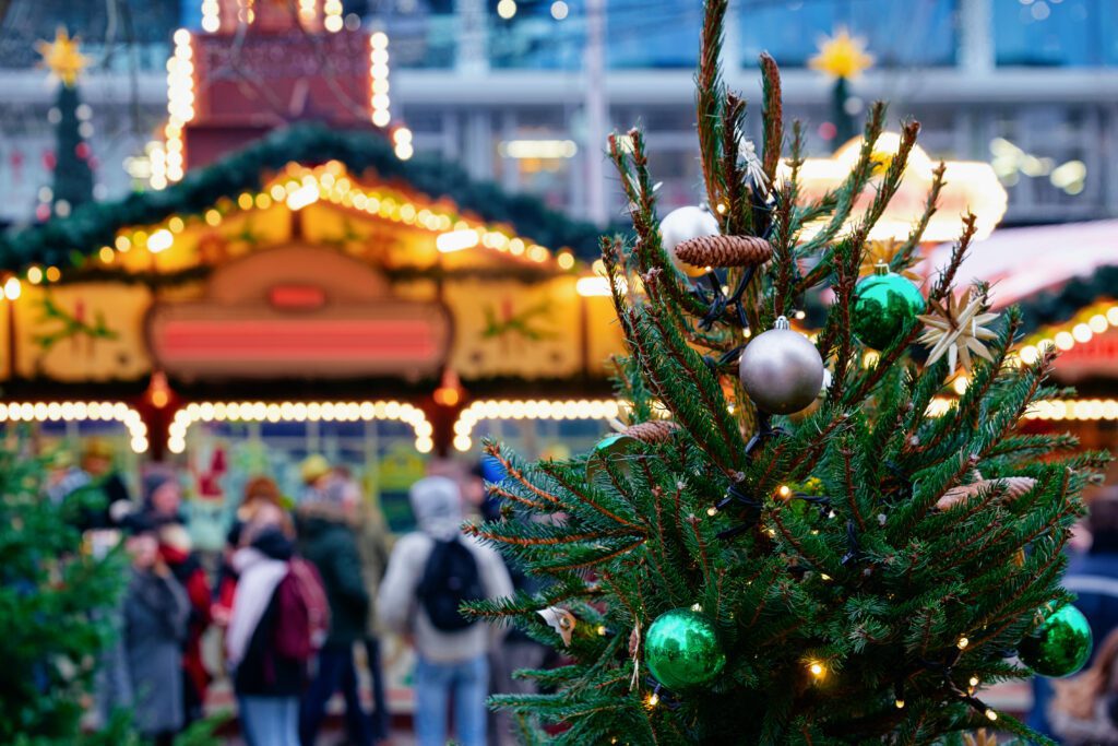 christmas tree in front of a christmas market