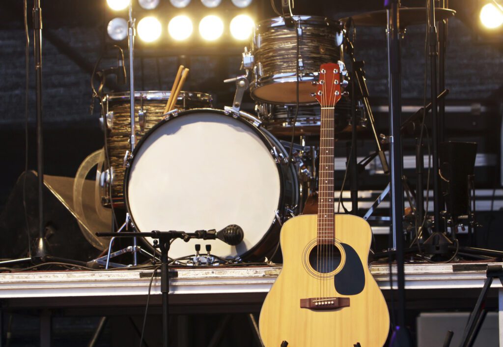 Concert stage with drum kit, and acoustic guitar