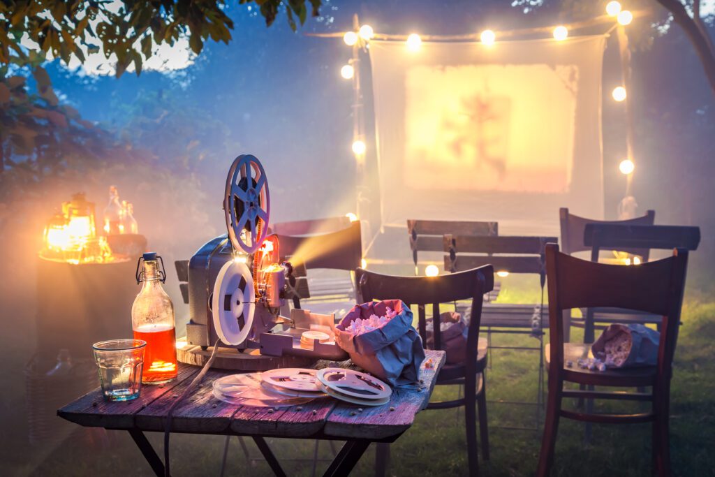 Small cinema in the summer garden in the evening