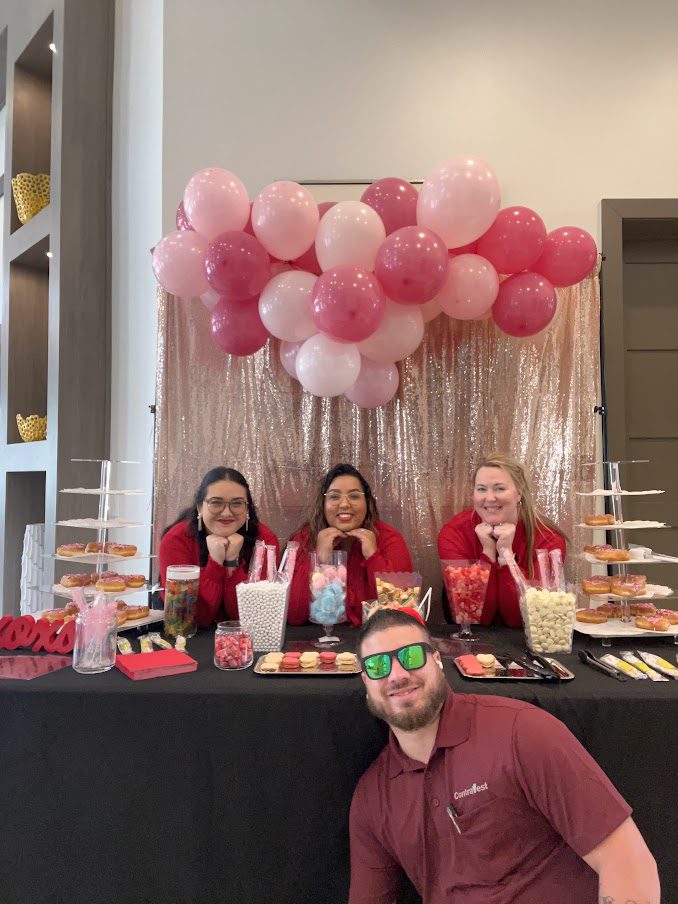 Addison leasing team posing with treat table