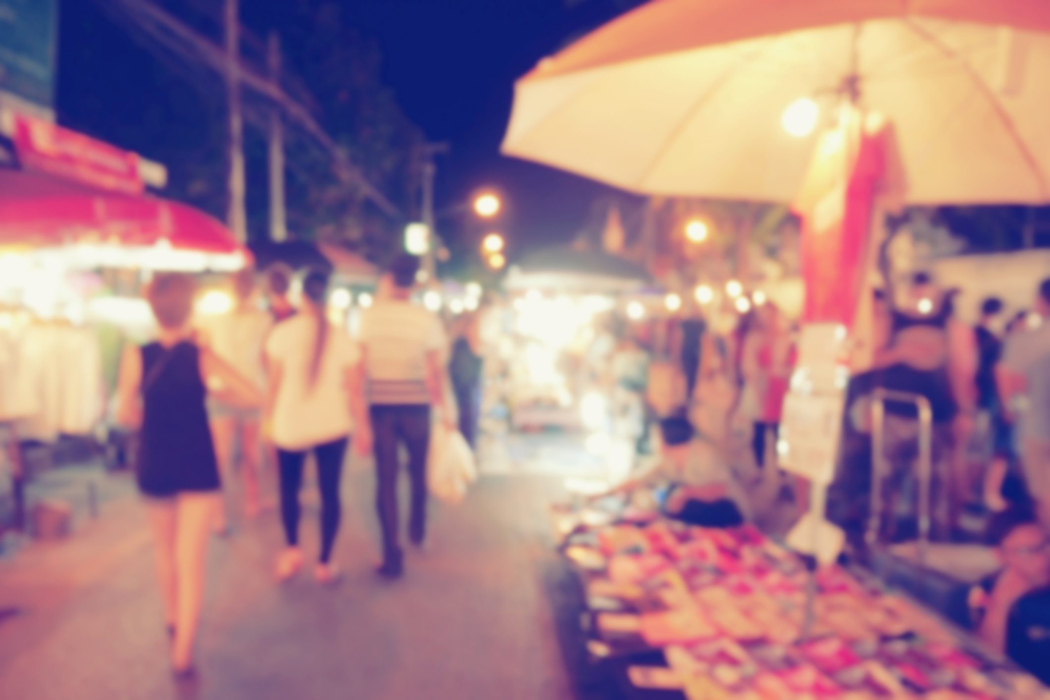 vintage photo effect of blurred people walking at night market walking street, Chiang Mai, Thailand