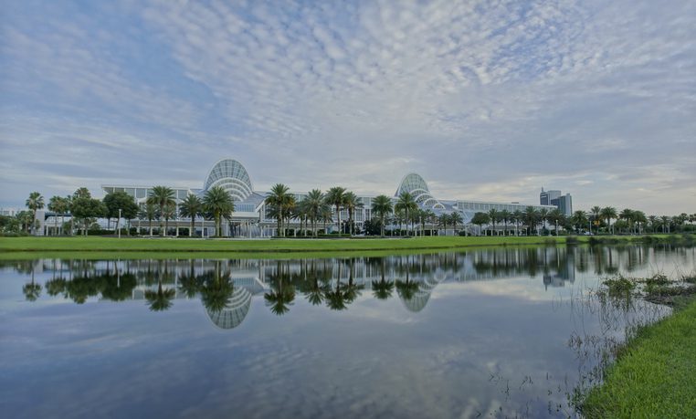 Dusk at the Orange County Convention Center while it reflects in the lake.  The center is the primary public convention center for the Central Florida region. The center currently ranks as the second largest convention center in the United States.