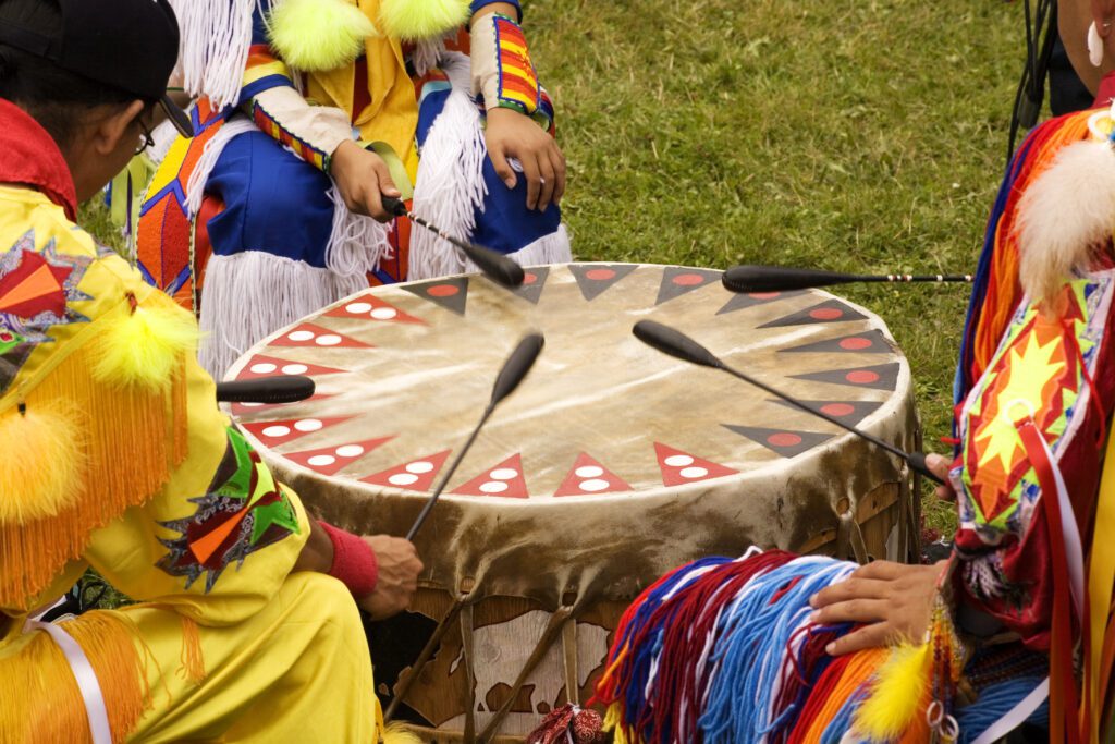 Beating Drum at Indian Pow Wow  Teamwork Colorful regalia