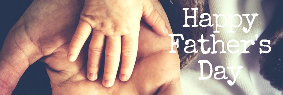 Childs hand on fathers hand celebrating Fathers Day