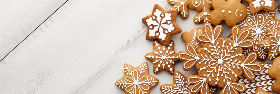 Christmas gingerbread cookies set on white wooden background, top view